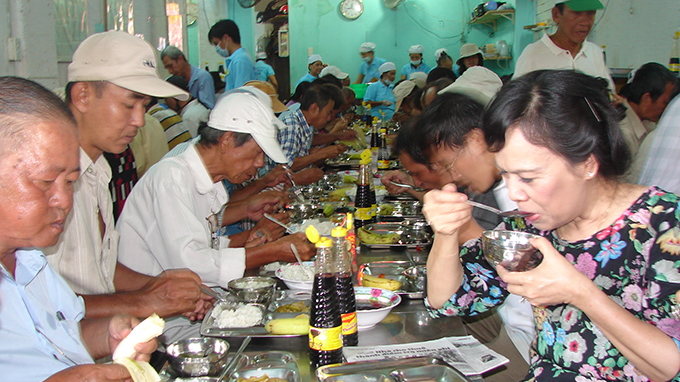 Phu nh&acirc;n chủ tịch nước Trương Tấn Sang - b&agrave; Mai Thị Hạnh đến ủng hộ một qu&aacute;n cơm cho người ngh&egrave;o