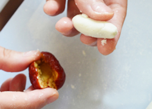 Tiếp đ&oacute;, lấy từng miếng bột nhỏ v&agrave; nặn d&agrave;i vừa với chiều d&agrave;i của t&aacute;o t&agrave;u rồi nhồi v&agrave;o b&ecirc;n trong quả t&aacute;o.