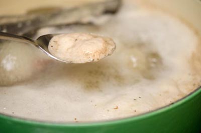 Khi nồi canh s&ocirc;i, hớt bỏ bọt.