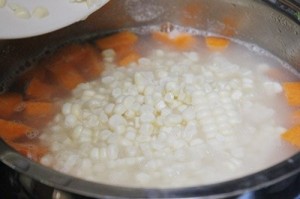Sau đ&oacute; th&ecirc;m khoai lang, ng&ocirc;, v&agrave;o đun c&ugrave;ng, lửa nhỏ, đun đến khi ăn thử thấy hạt ng&ocirc; mềm, bạn th&ecirc;m từ từ đường v&agrave;o, đun s&ocirc;i, lửa nhỏ d&ugrave;ng mu&ocirc;i khuấy nhẹ để ch&egrave; kh&ocirc;ng bị d&iacute;nh đ&aacute;y nồi. Nếu muốn ăn vị b&eacute;o hơn, bạn c&oacute; thể ch&acirc;m nước cốt dừa v&agrave;o đun c&ugrave;ng.