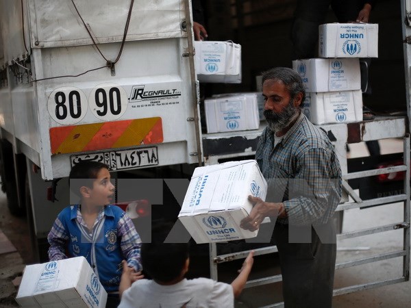 Người d&acirc;n Syria nhận h&agrave;ng cứu trợ tại khu vực Harasta, ngoại &ocirc; thủ đ&ocirc; Damascus, theo tình hình chi&ecirc;́n sự Syria mới nh&acirc;́t 