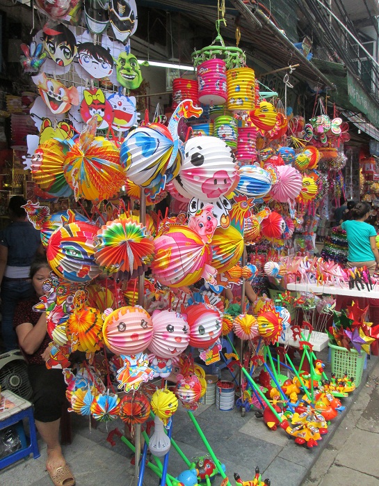 Thị trường ngập tràn đồ chơi trung thu. Mỗi chiếc đèn lồng gấp giấy này, loại to với những hình con vật như heo, gà, ngỗng, chim công giá khoảng 45 ngàn đồng/chiếc. Loại nhỏ hơn khoảng 30 - 35 ngàn đồng/chiếc. Sản phẩm này theo người bán có nguồn gốc từ Trung Quốc. Ảnh: Nguyễn Nam