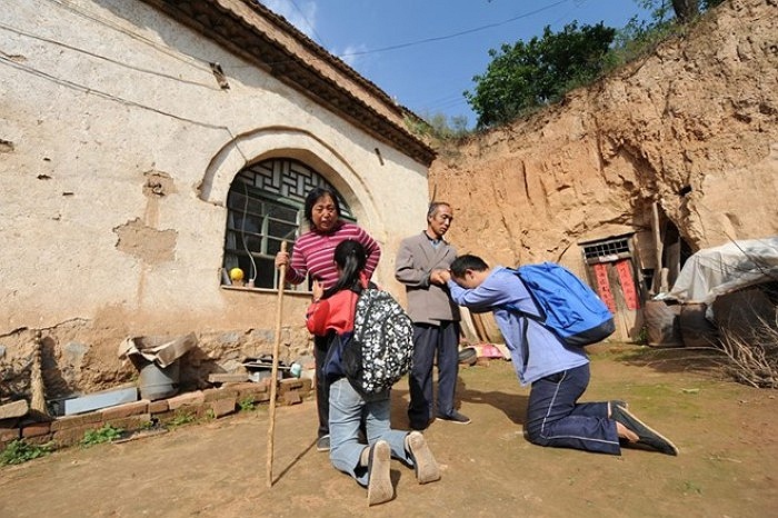 H&igrave;nh ảnh hai t&acirc;n sinh vi&ecirc;n quỳ lạy cha mẹ trước khi l&ecirc;n đường nhập học khiến nhiều người cảm động