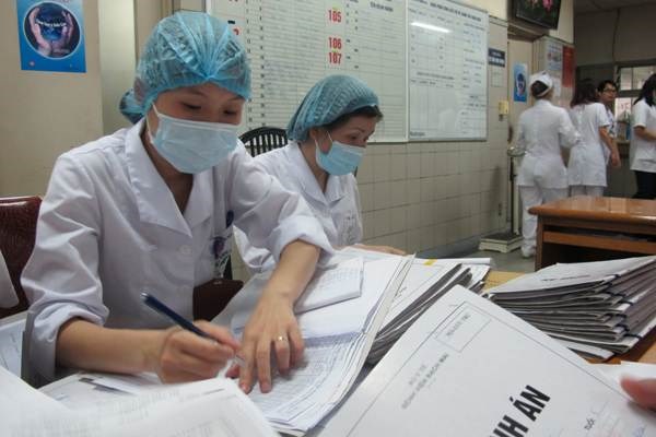 Nhân viên y tế không ngơi tay với những chồng bệnh án dày hàng tập.